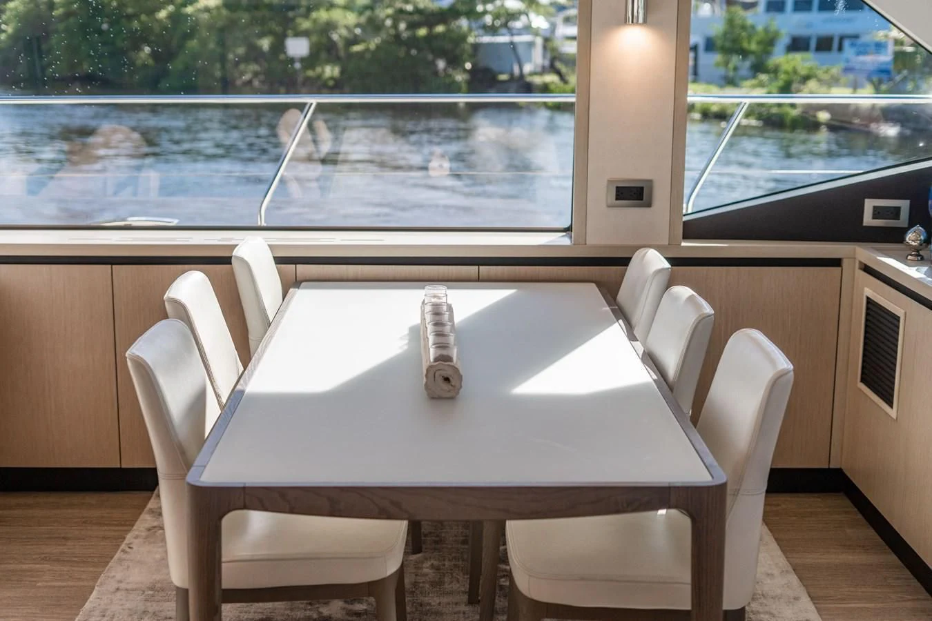 a table with chairs and a window aboard PLANE TO SEA Yacht for Sale