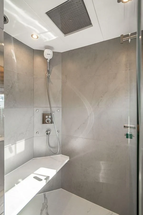 a shower with a shower head aboard PLANE TO SEA Yacht for Sale