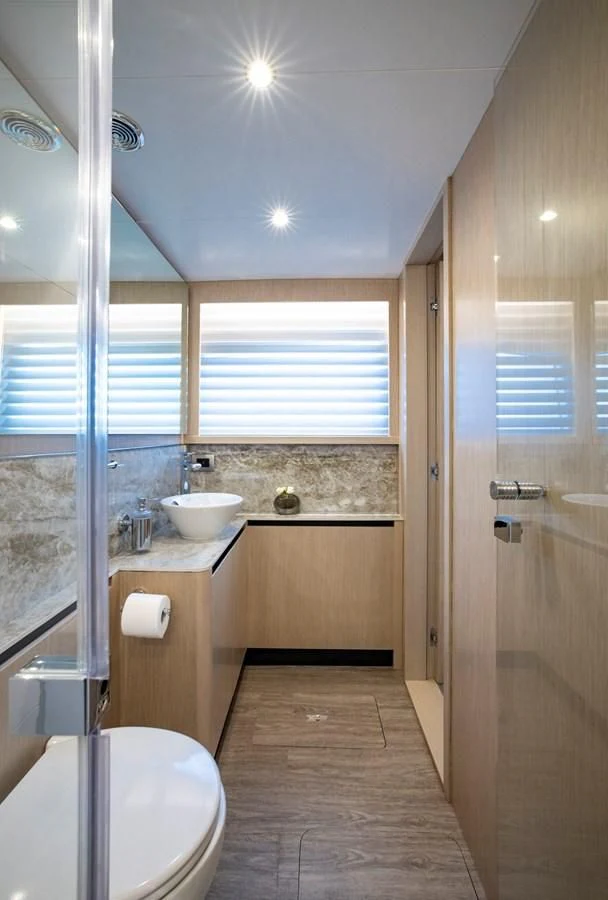 a bathroom with a sink and a toilet aboard PLANE TO SEA Yacht for Sale