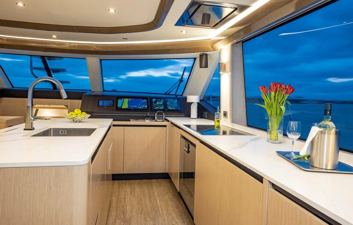 a kitchen with a large window aboard PLANE TO SEA Yacht for Sale
