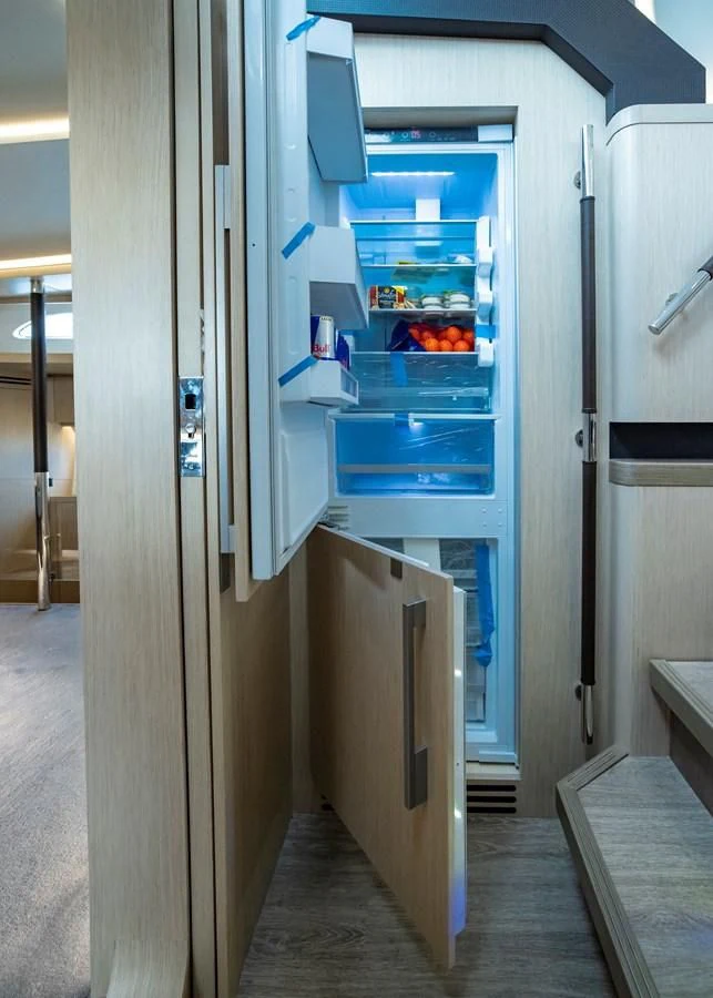 a refrigerator with its door open aboard PLANE TO SEA Yacht for Sale