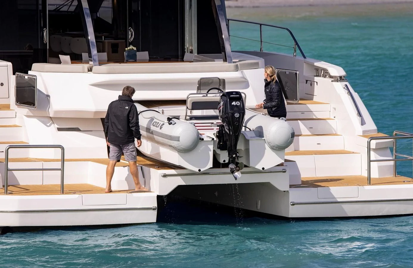 a man and a woman standing on a boat aboard PLANE TO SEA Yacht for Sale