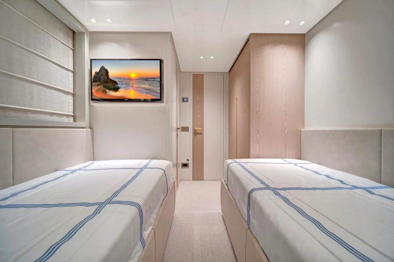 a room with beds and a tv aboard JICJ Yacht for Sale