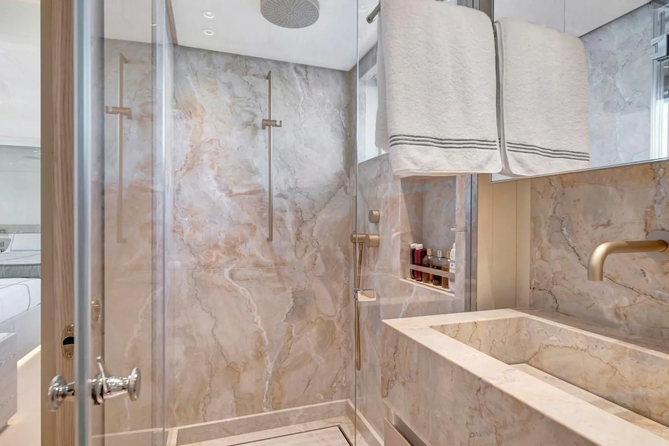 a bathroom with a glass shower aboard JICJ Yacht for Sale