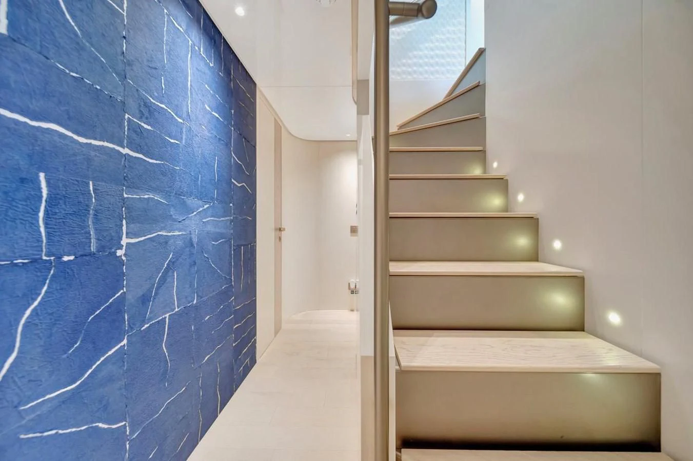 a staircase with blue walls aboard JICJ Yacht for Sale