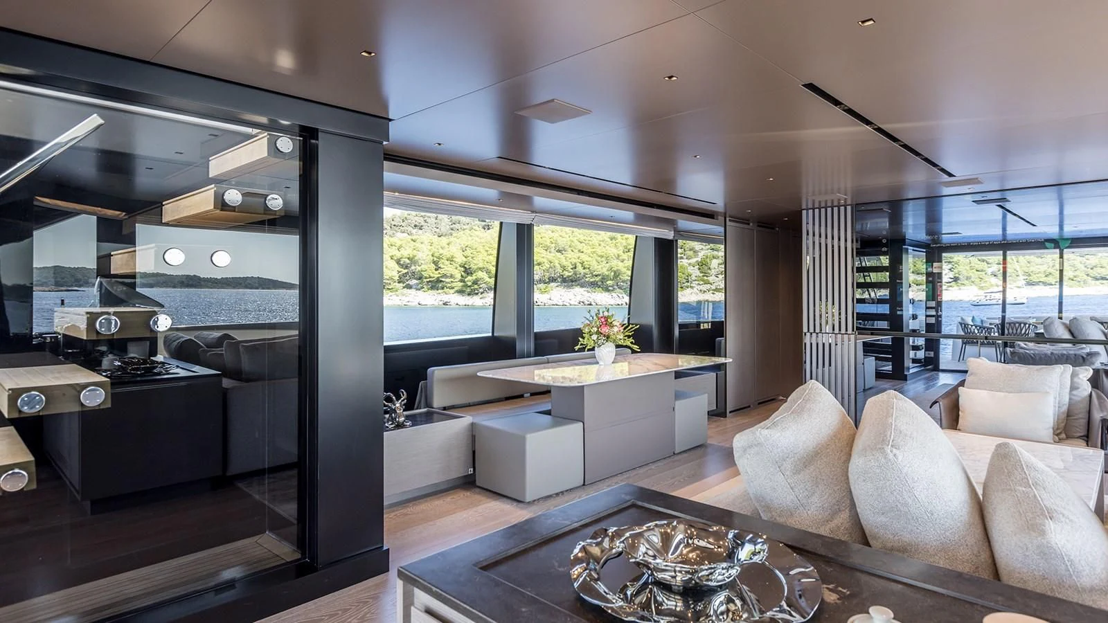 a modern living room with a large glass coffee table aboard JICJ Yacht for Sale