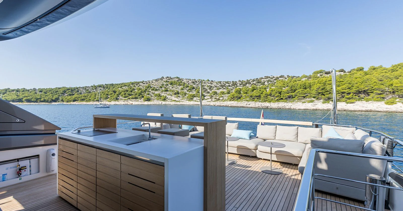 a deck with a view of a lake and trees aboard JICJ Yacht for Sale