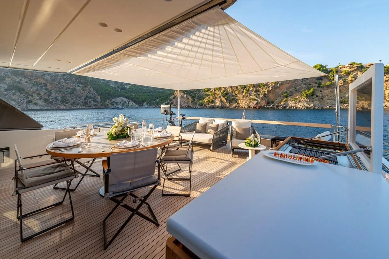 a table and chairs on a deck aboard JICJ Yacht for Sale