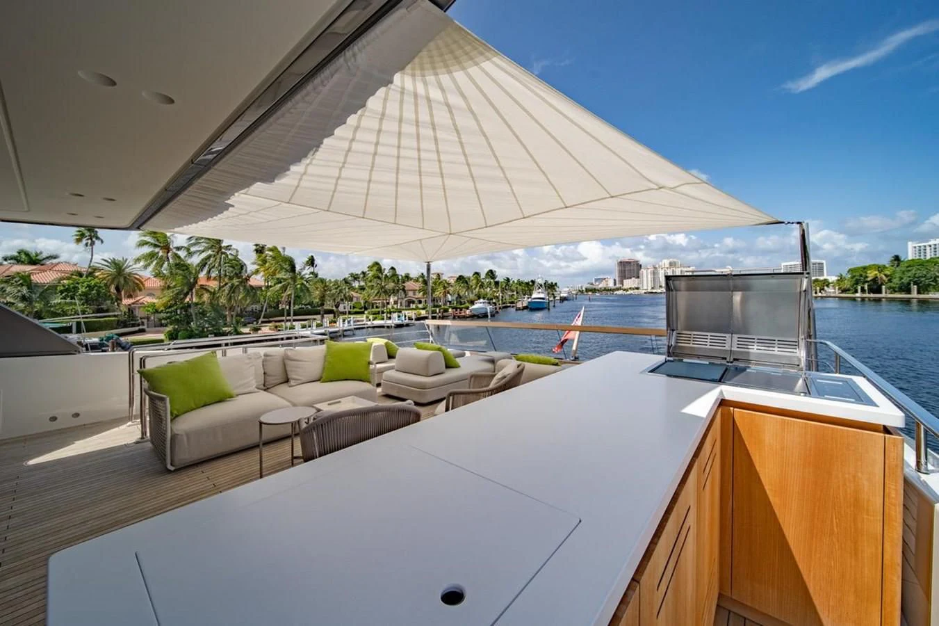 a large white lounge chair next to a large white table on a boat aboard JICJ Yacht for Sale