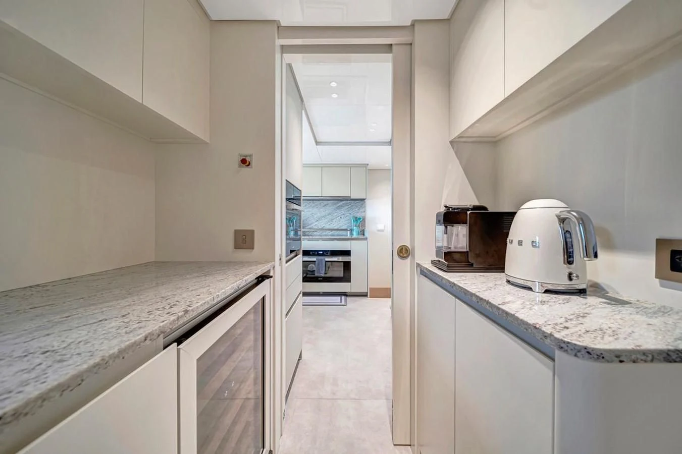 a kitchen with white cabinets aboard JICJ Yacht for Sale