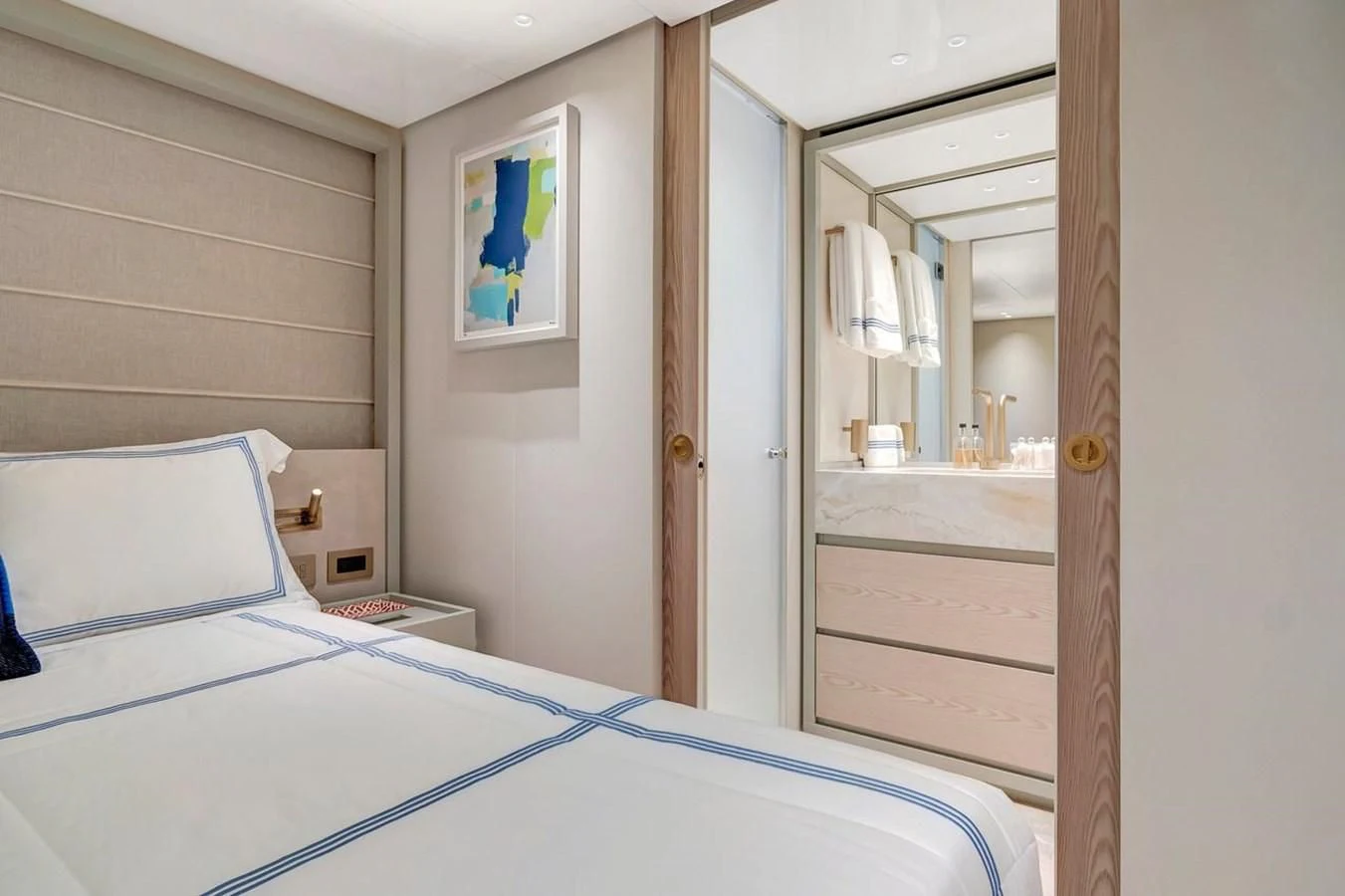 a bedroom with a mirror and a bed aboard JICJ Yacht for Sale