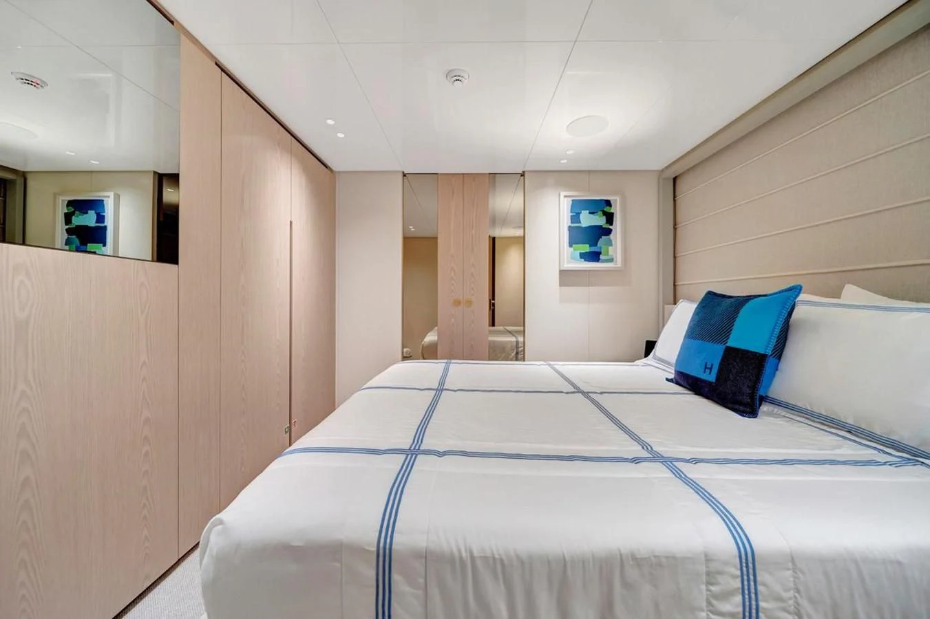 a room with a bed and a mirror aboard JICJ Yacht for Sale