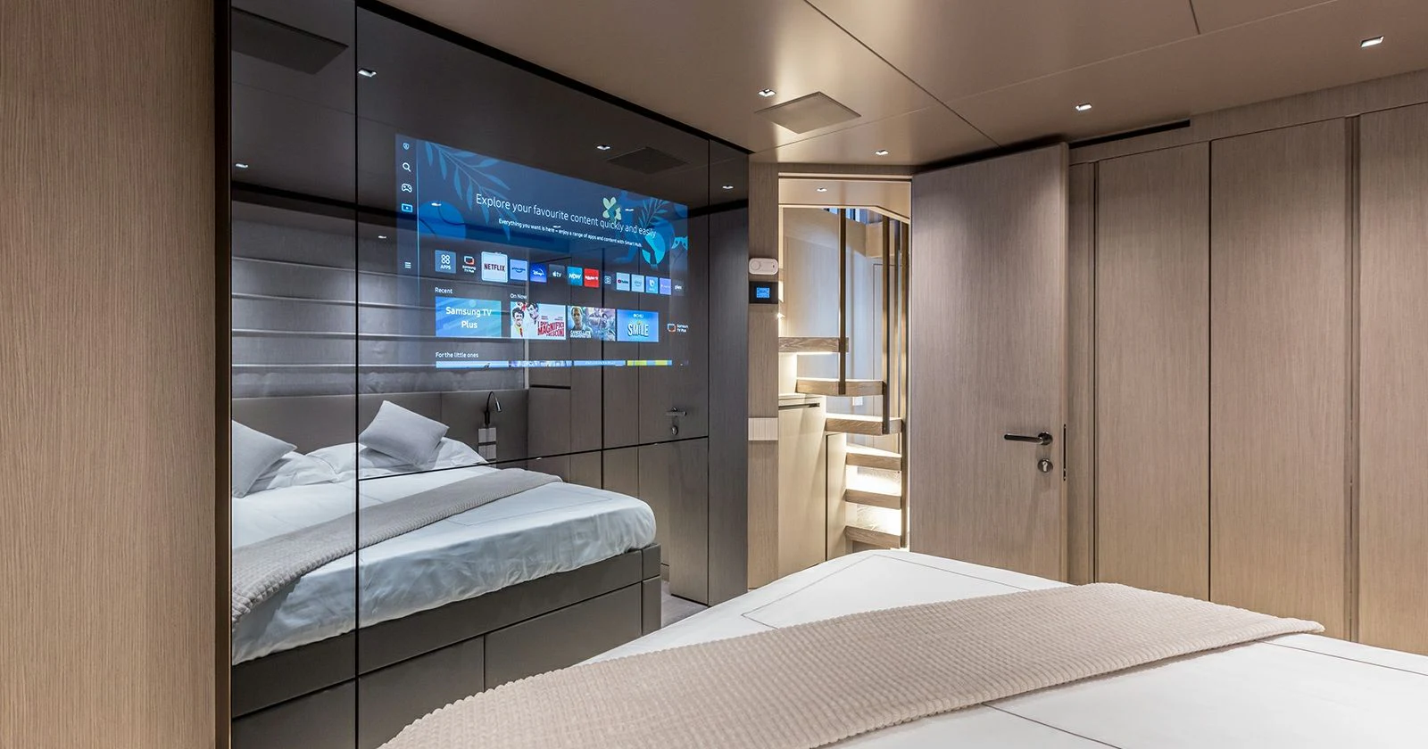 a room with a bed and a tv on the wall aboard JICJ Yacht for Sale