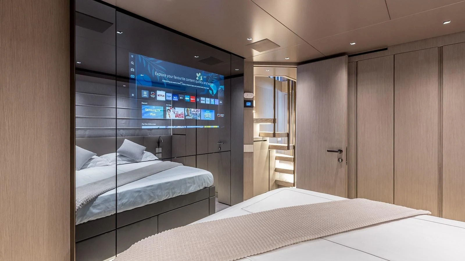 a room with a bed and a tv on the wall aboard JICJ Yacht for Sale
