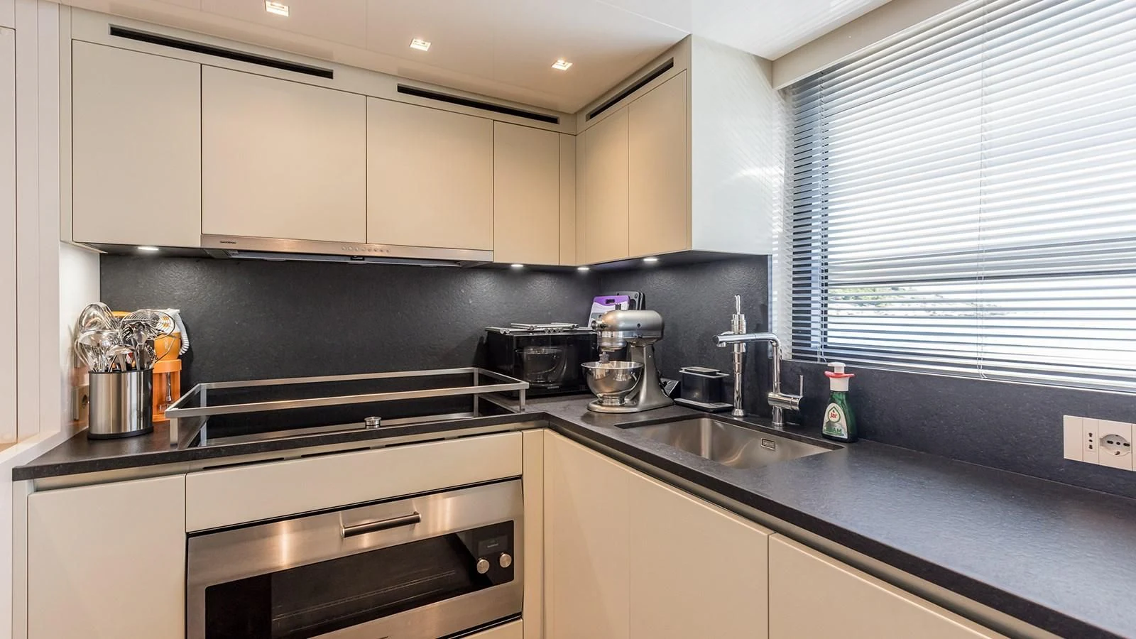 a kitchen with a sink and cabinets aboard JICJ Yacht for Sale