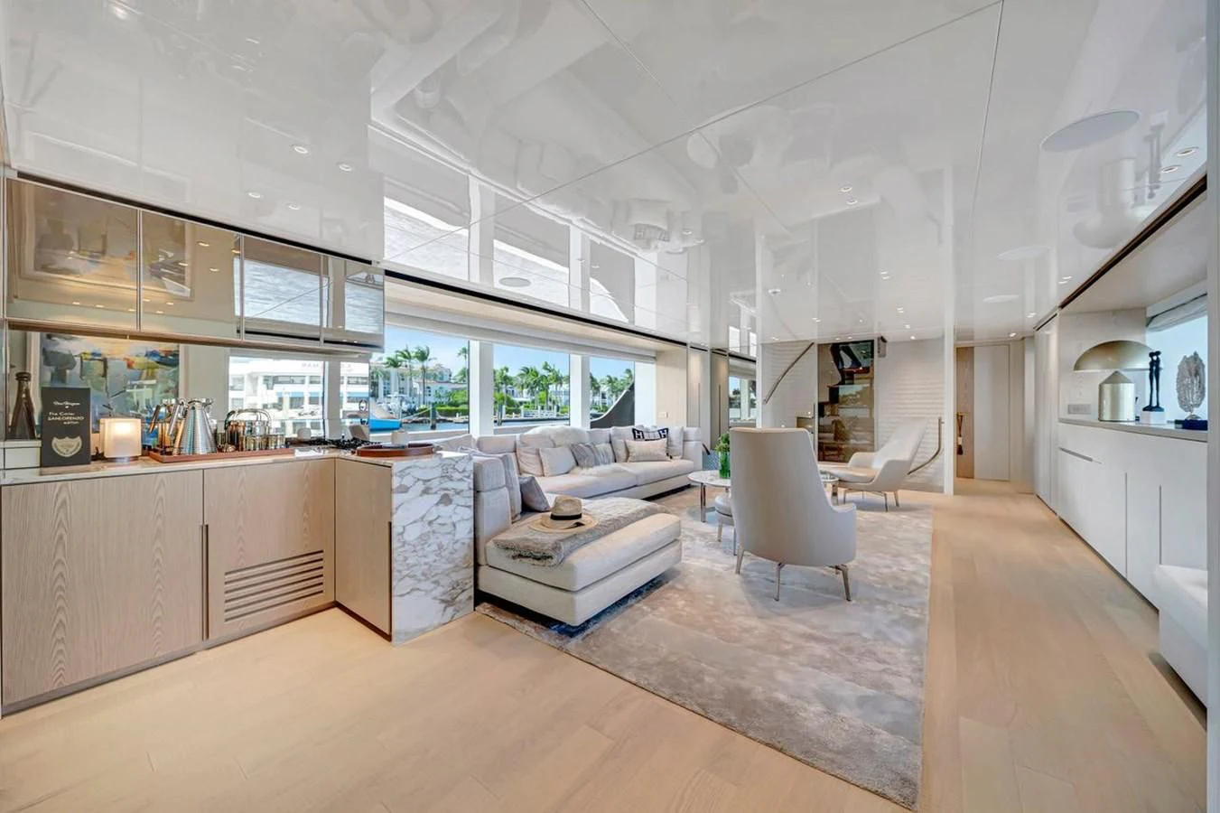 a large living room with white furniture aboard JICJ Yacht for Sale