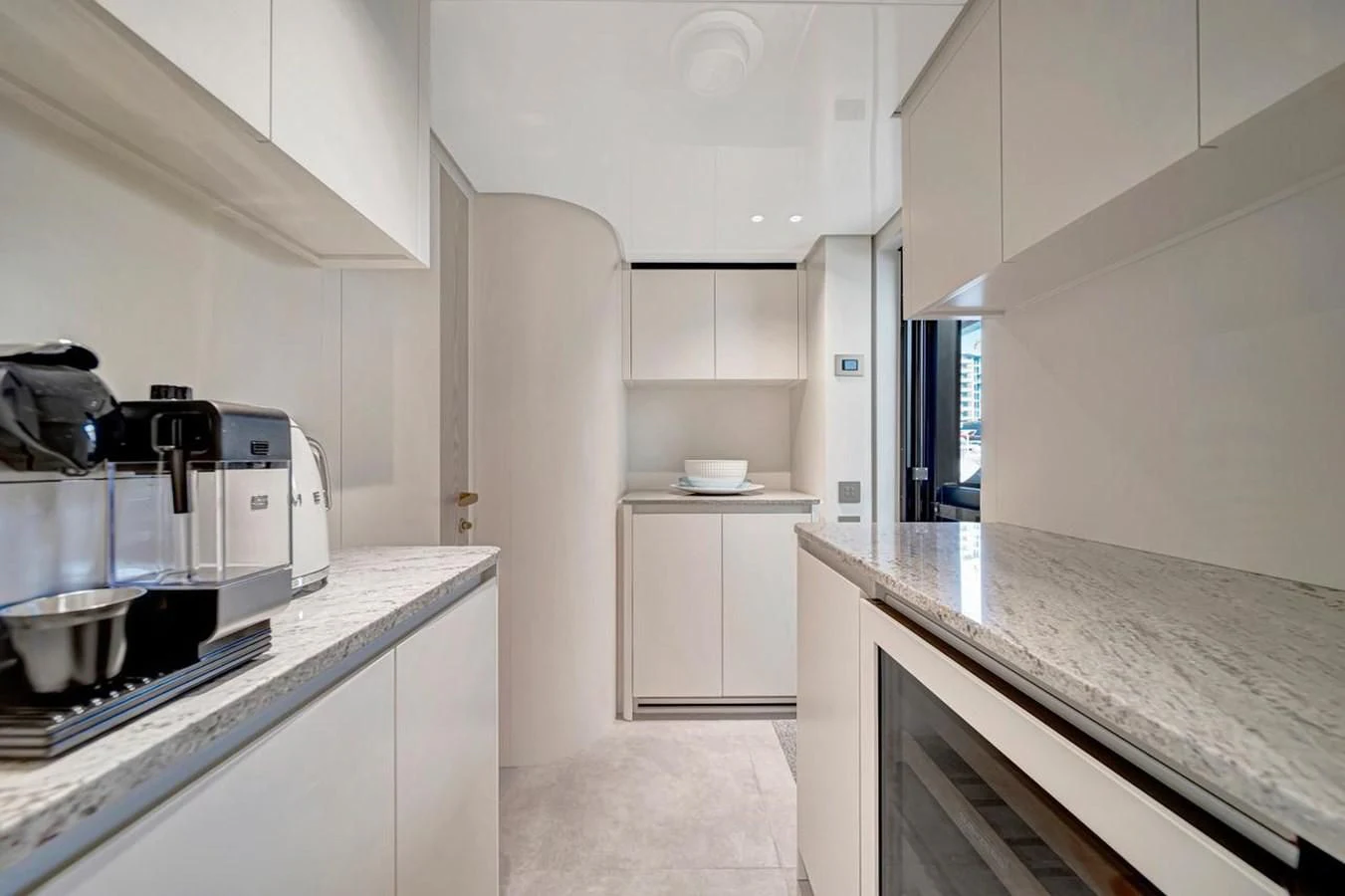 a kitchen with white cabinets aboard JICJ Yacht for Sale