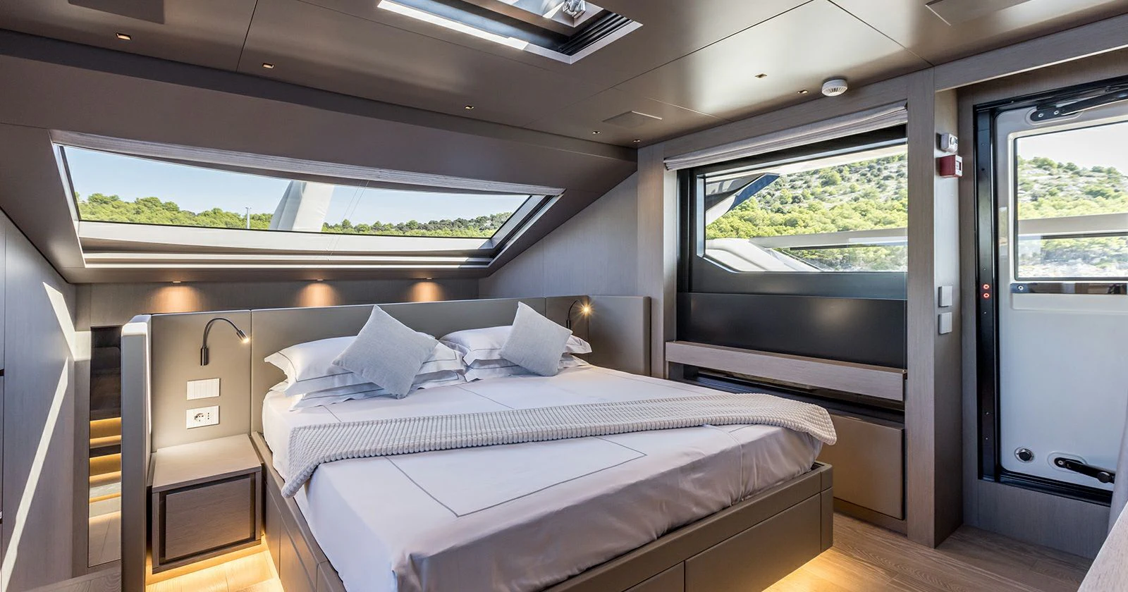 a room with a bed and a window aboard JICJ Yacht for Sale