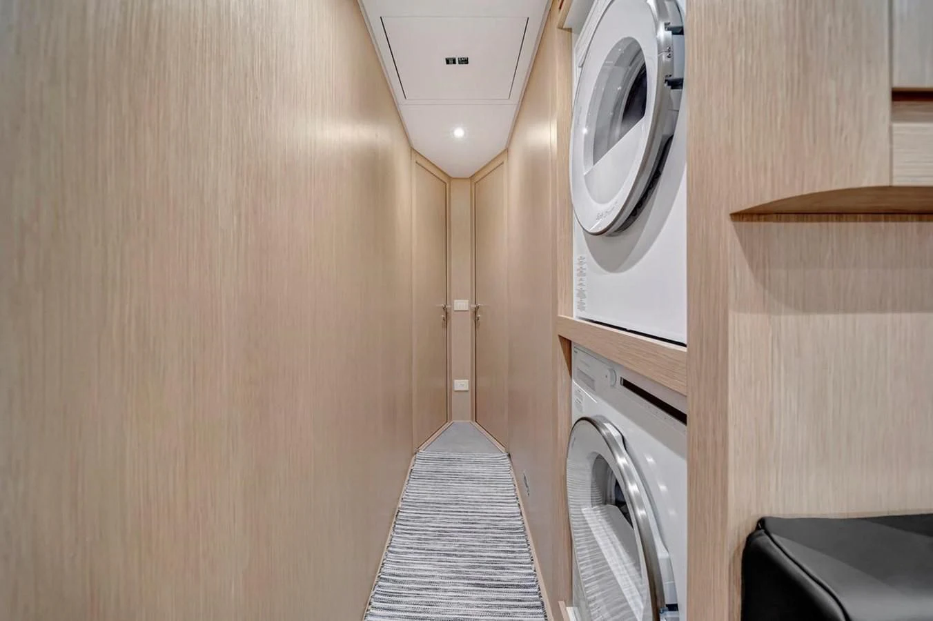 a small room with a washer and dryer aboard JICJ Yacht for Sale