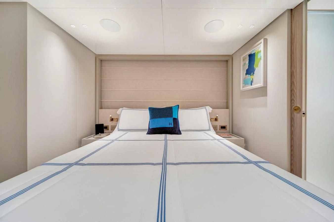 a bed with blue sheets aboard JICJ Yacht for Sale