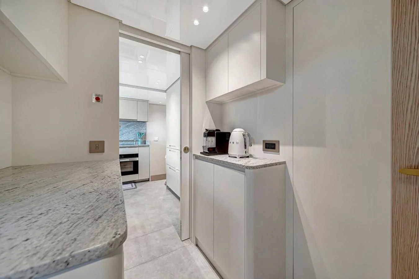 a kitchen with white cabinets aboard JICJ Yacht for Sale