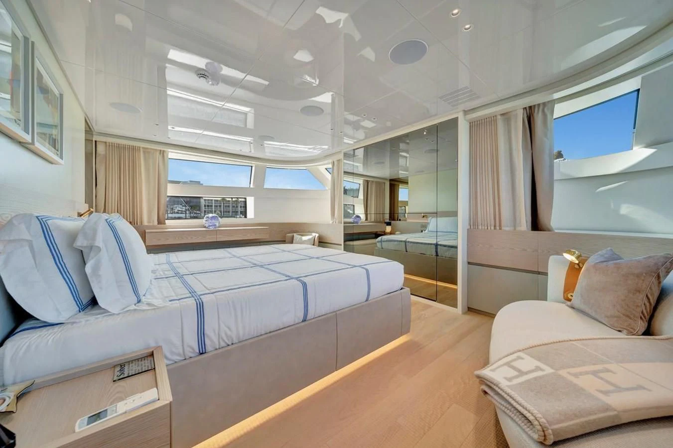 a bedroom with a bed and a large window aboard JICJ Yacht for Sale