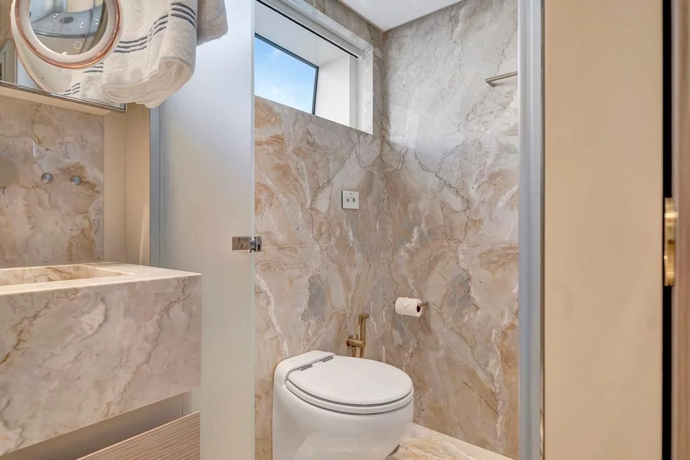 a bathroom with a toilet and a sink aboard JICJ Yacht for Sale