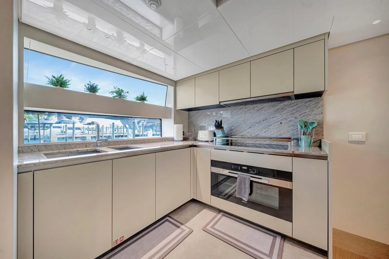 a kitchen with white cabinets aboard JICJ Yacht for Sale