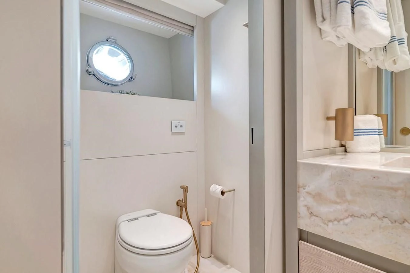 a bathroom with a toilet and a mirror aboard JICJ Yacht for Sale