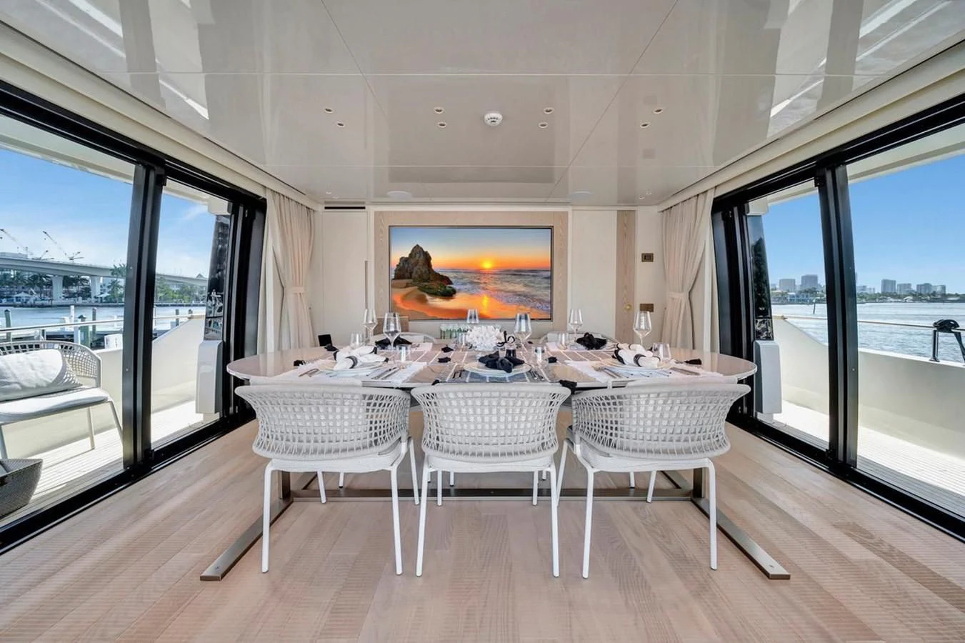 a large room with a table and chairs and a large window aboard JICJ Yacht for Sale