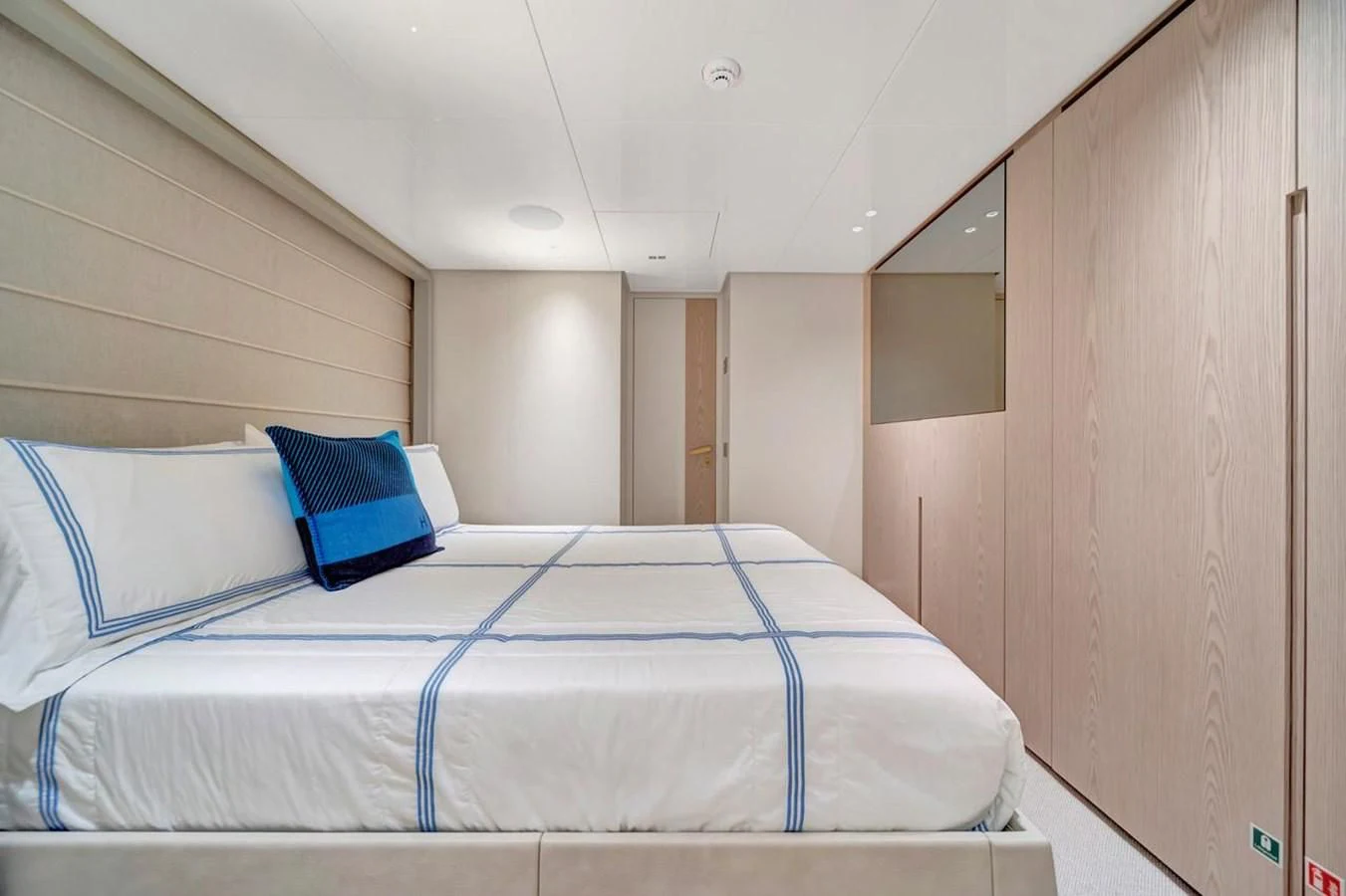 a bed with blue sheets aboard JICJ Yacht for Sale
