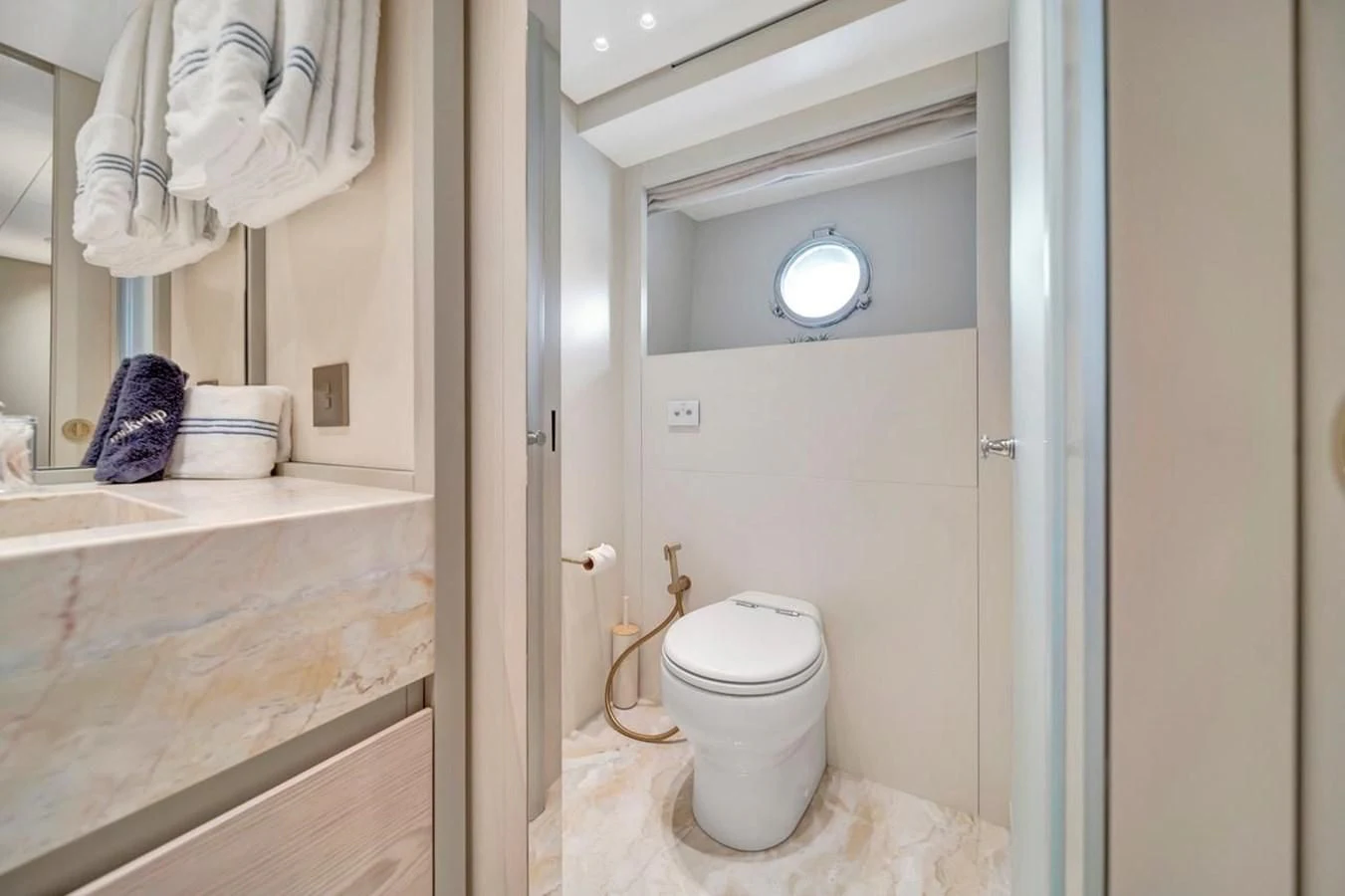 a bathroom with a toilet and a sink aboard JICJ Yacht for Sale