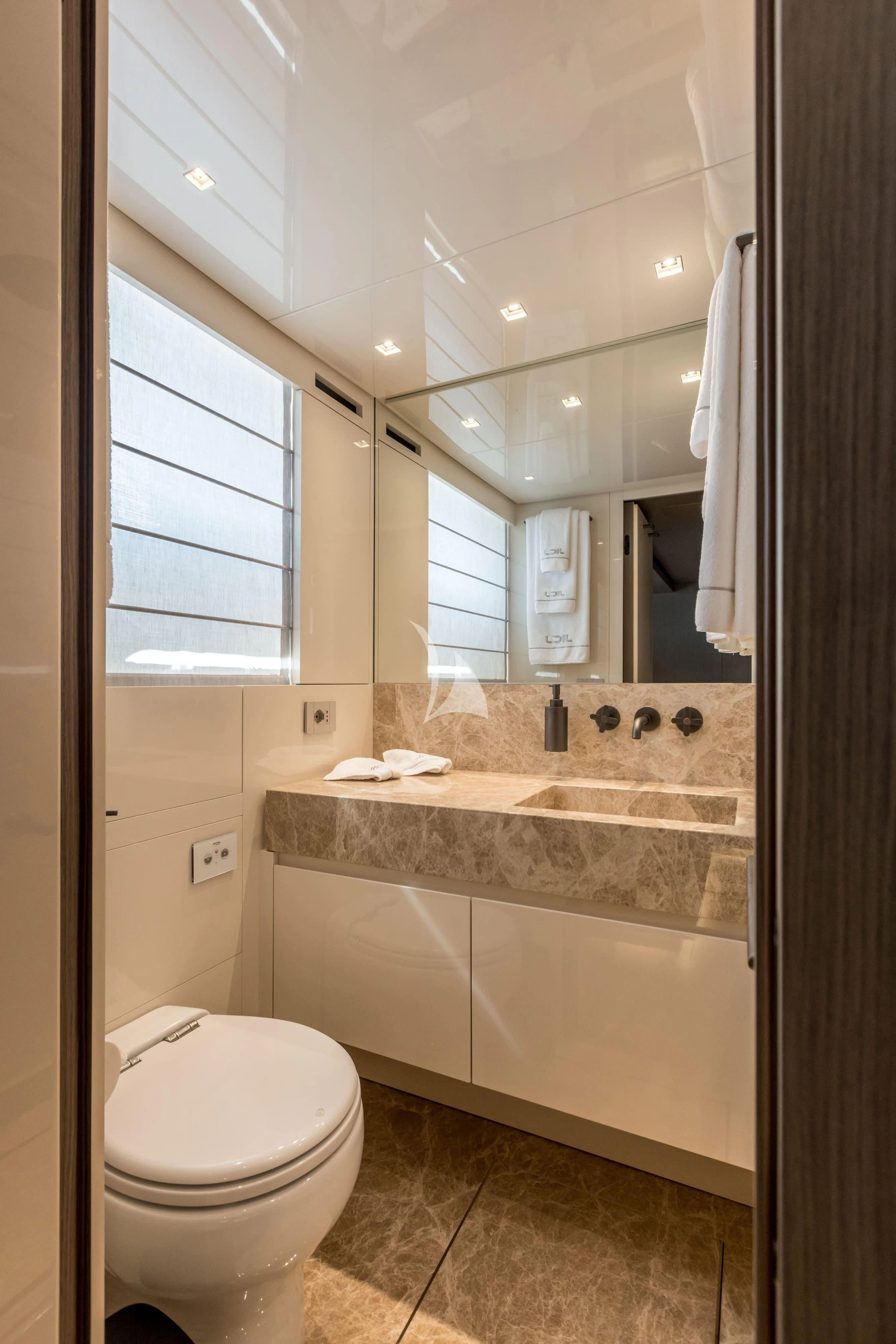 a bathroom with a large mirror aboard JICJ Yacht for Sale