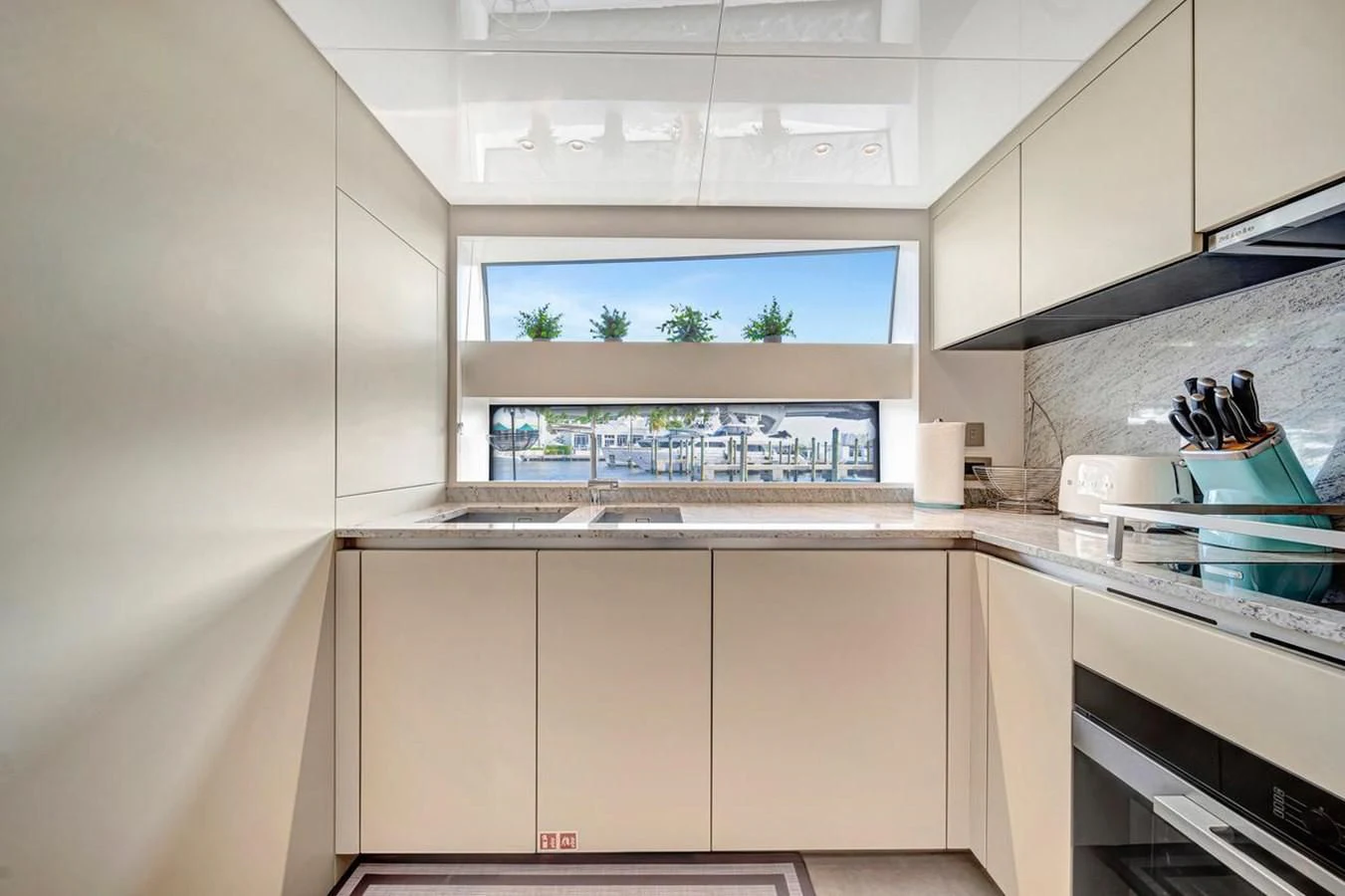 a kitchen with white cabinets aboard JICJ Yacht for Sale
