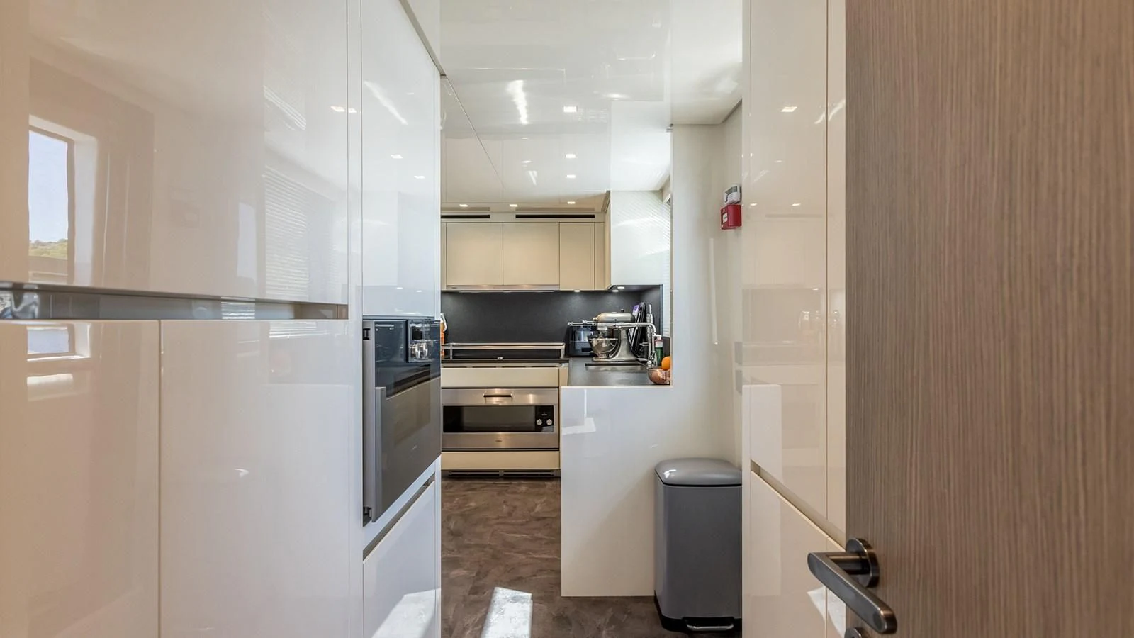 a kitchen with white cabinets aboard JICJ Yacht for Sale