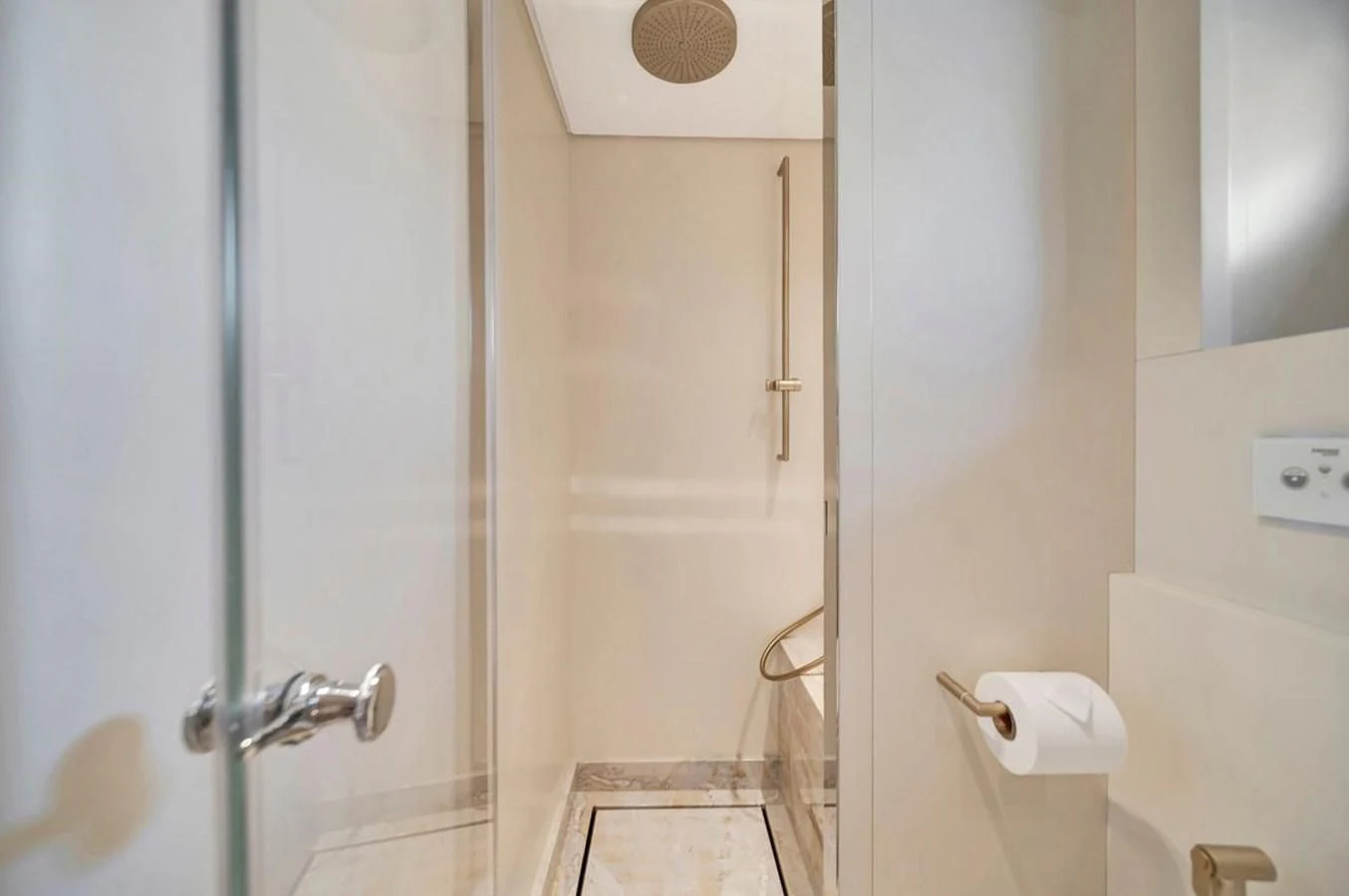a bathroom with a glass shower door aboard JICJ Yacht for Sale