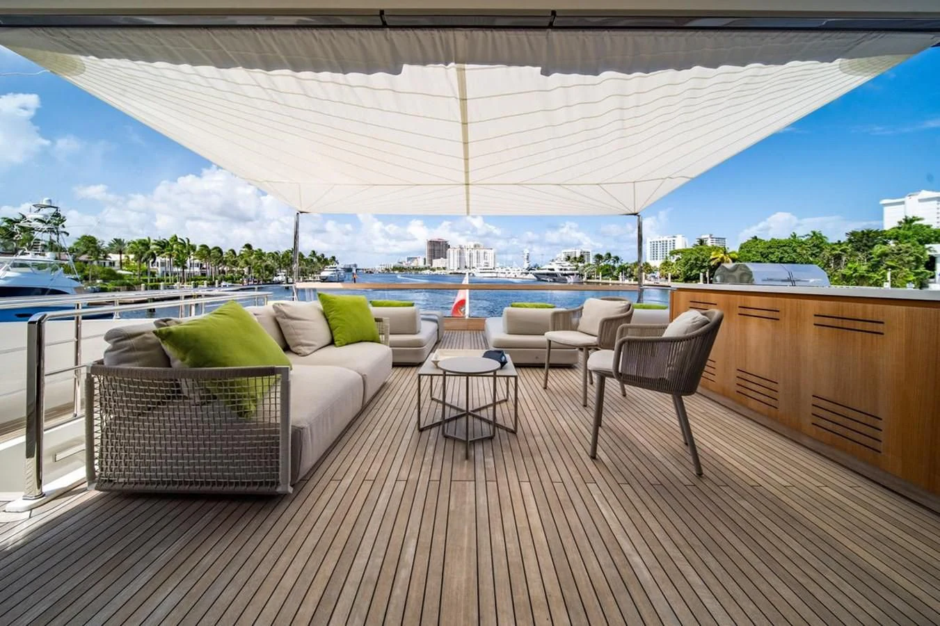 a deck with a view of a city and a large body of water aboard JICJ Yacht for Sale
