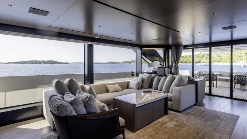 a living room with a large window aboard JICJ Yacht for Sale