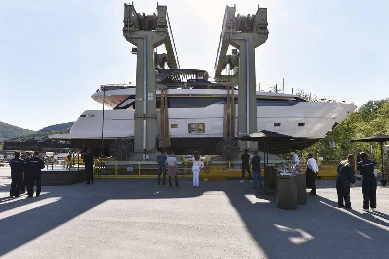 a group of people standing around a military ship aboard JICJ Yacht for Sale