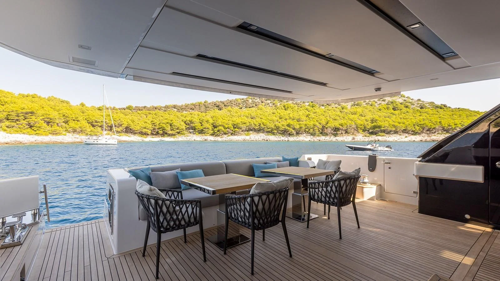 a patio with chairs and tables aboard JICJ Yacht for Sale