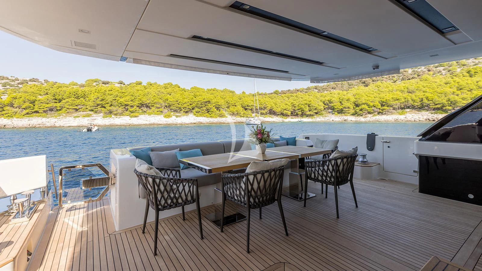 a table and chairs on a deck aboard JICJ Yacht for Sale