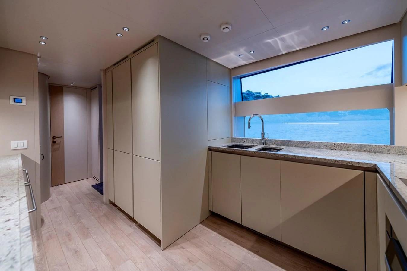 a large kitchen with a large window aboard JICJ Yacht for Sale