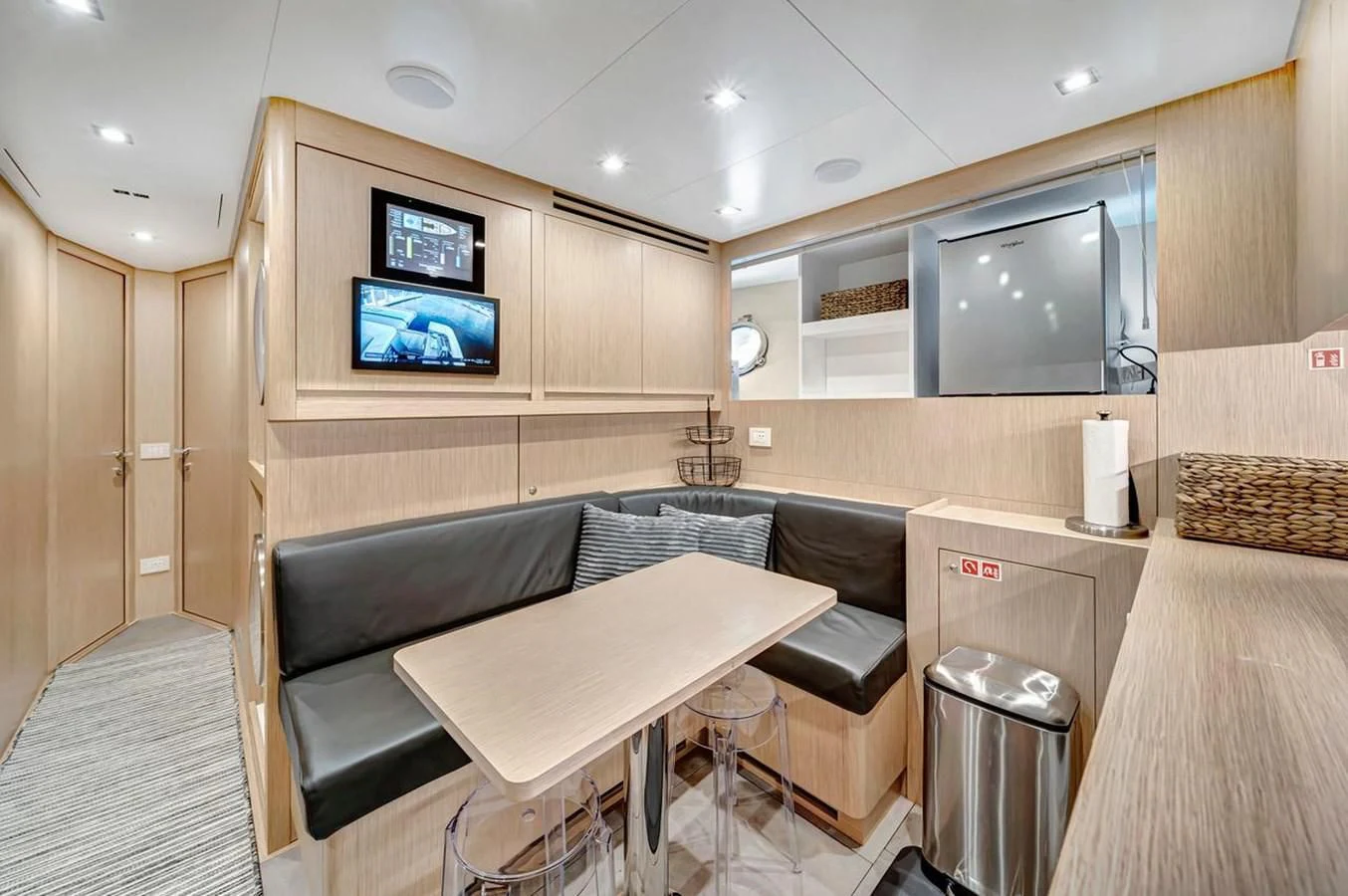 a room with a couch and a tv on the wall aboard JICJ Yacht for Sale