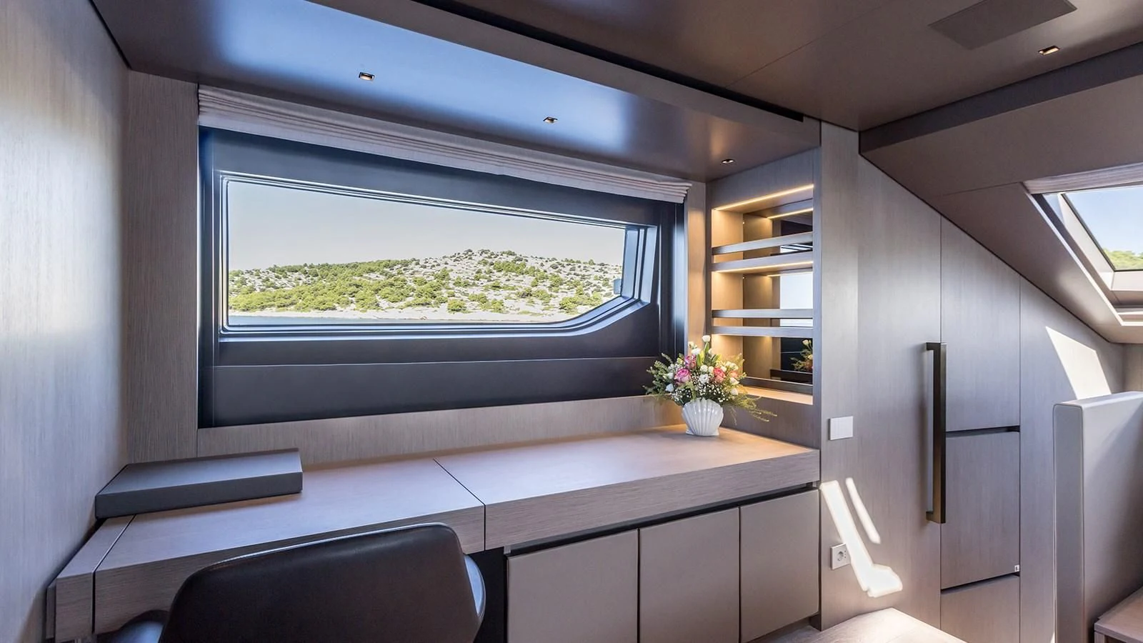 a room with a window and a view of the grass aboard JICJ Yacht for Sale