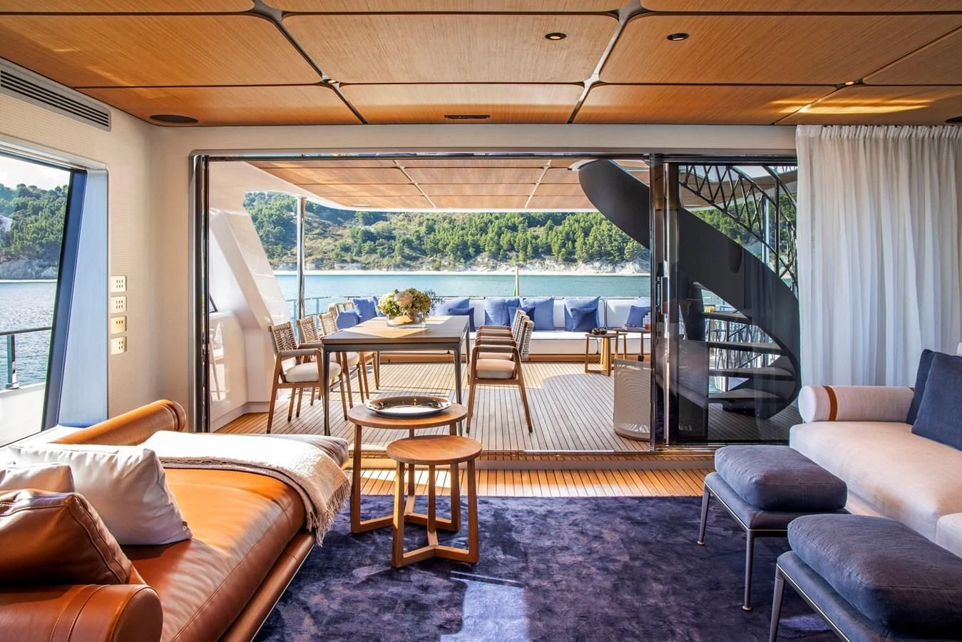 a living room with a large patio aboard MIA CA Yacht for Sale