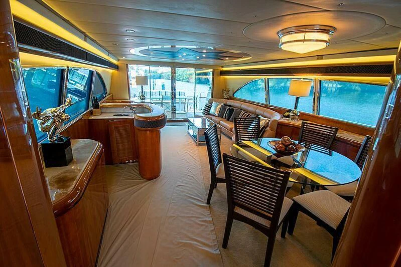 a room with a table and chairs aboard ALMAR Yacht for Sale