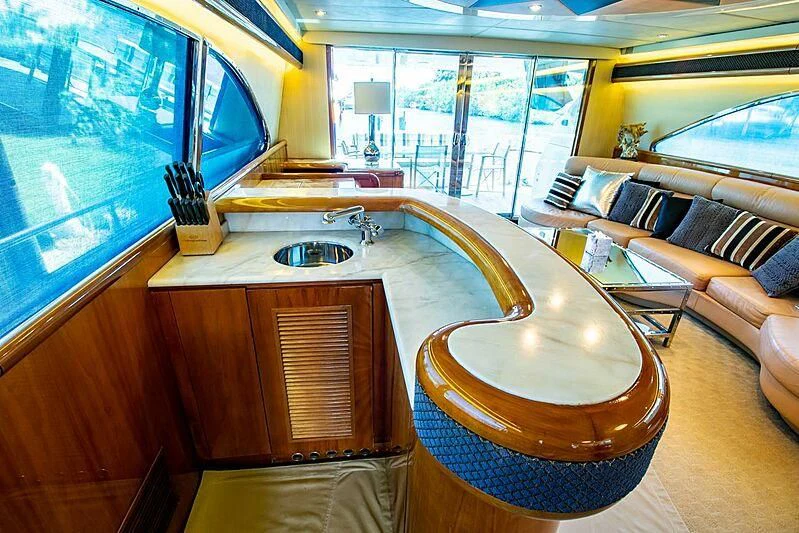 a room with a table and a tv aboard ALMAR Yacht for Sale