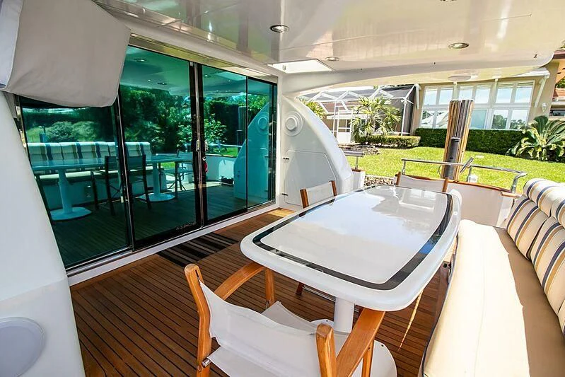 a table and chairs on a balcony aboard ALMAR Yacht for Sale