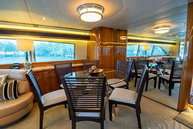 a room with a table and chairs aboard ALMAR Yacht for Sale