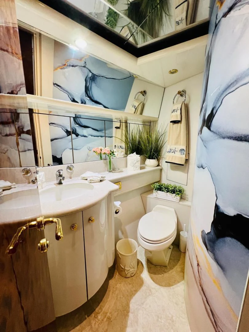 a bathroom with a sink toilet and a bathtub aboard MAGIC MOMENTS Yacht for Sale